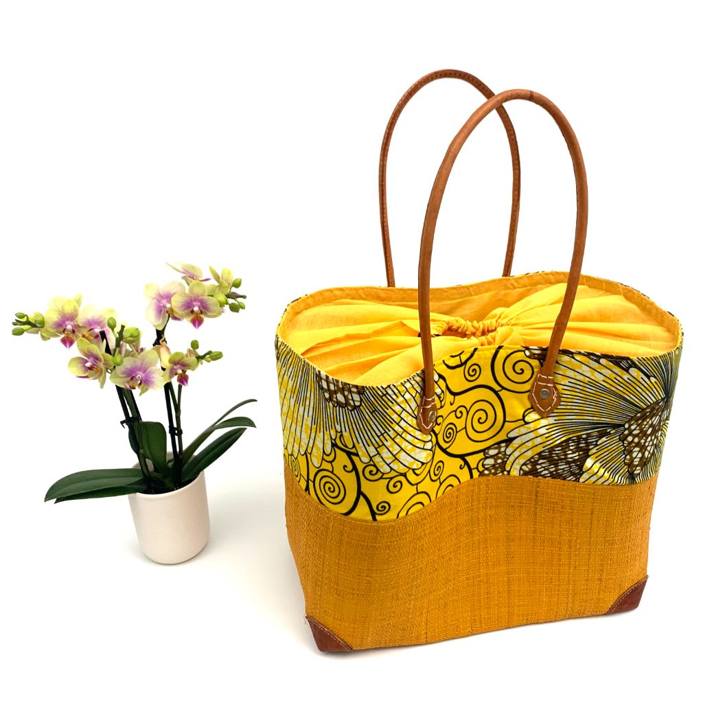 Yellow raffia basket in 3 different sizes,half raffia and half tissue wax, with inside pockets & leather handle.Handmade in Madagascar with love.