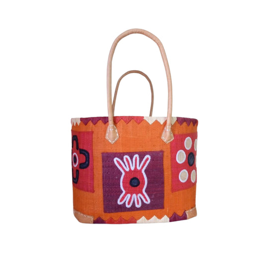 NatsNco handmade raffia women orange basket with pattern embroidery and leather handle & drawstring closure. Made in Madagascar