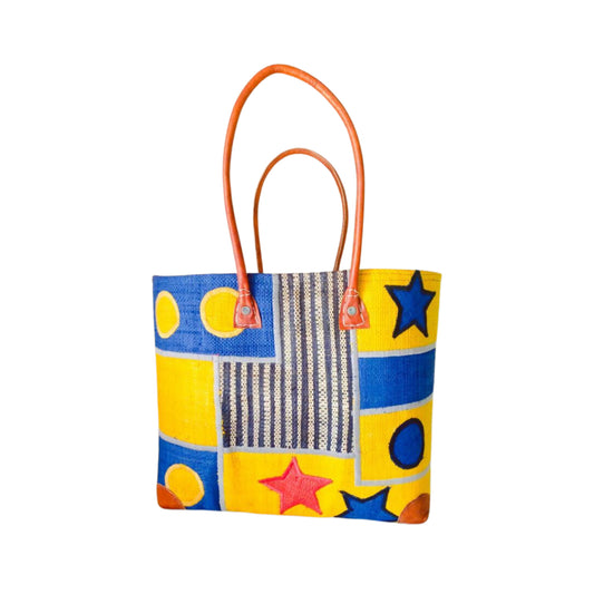 NatsNco handmade raffia, women,yellow and blue basket with star embroidery & design and leather handle & drawstring closure. Made in Madagascar